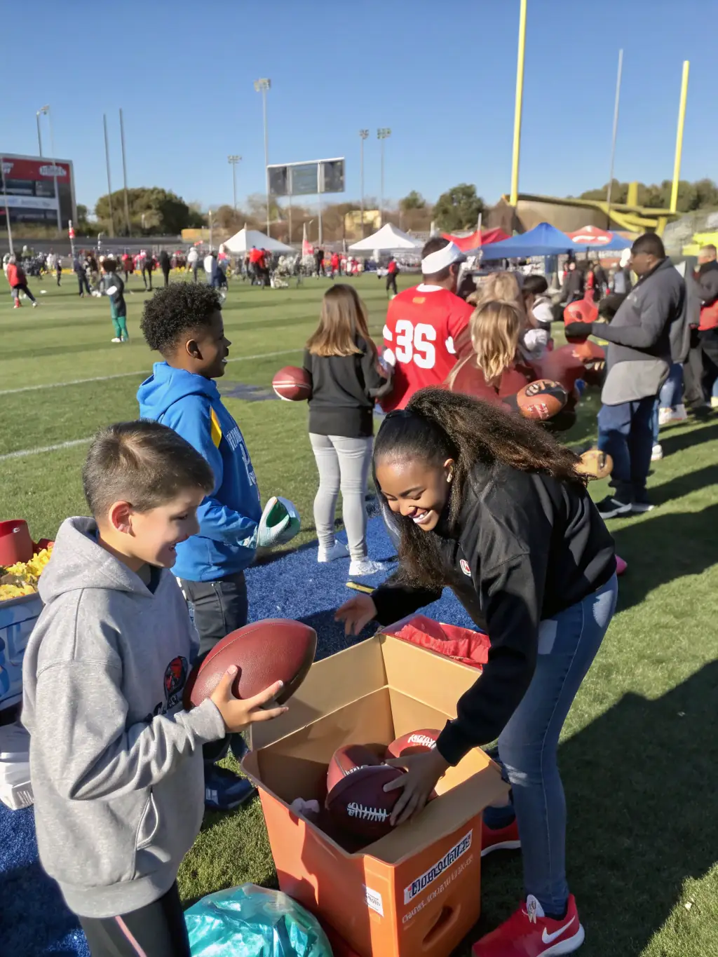 A group of volunteers and staff from ASC ASSOC SPORTIVE DE CHAMPS SECTION FOOT are setting up equipment for a football event, demonstrating their commitment to the community.